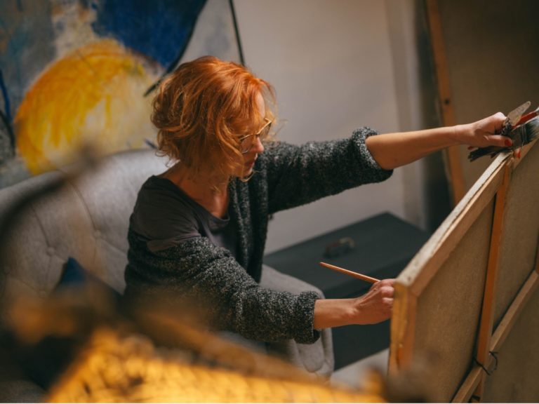 a-painting-of-a-woman-wearing-a-hat-with-feathers-on-her-head-and