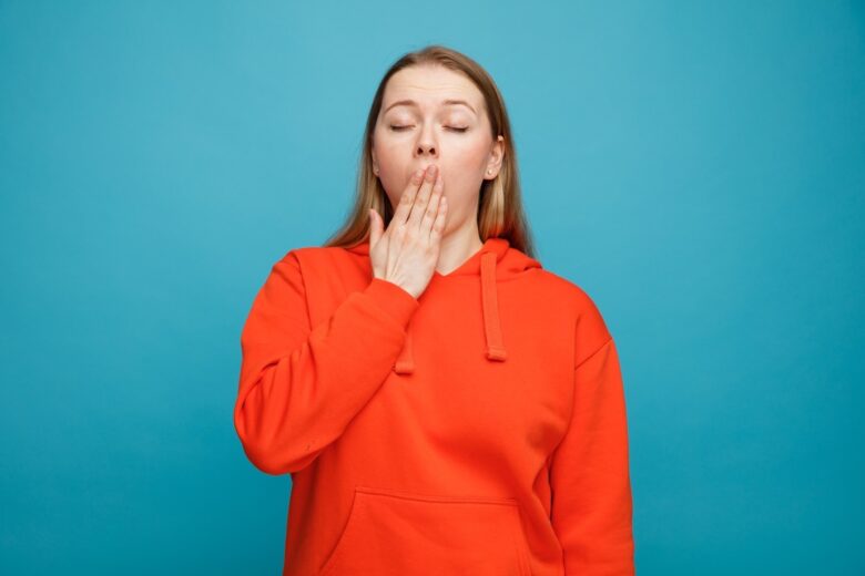 blonde woman yawning and tired