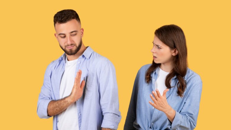 A man pulls away as a woman reacts to his boundary in a tense dating moment