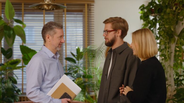 A home inspector speaks with buyers inside a house