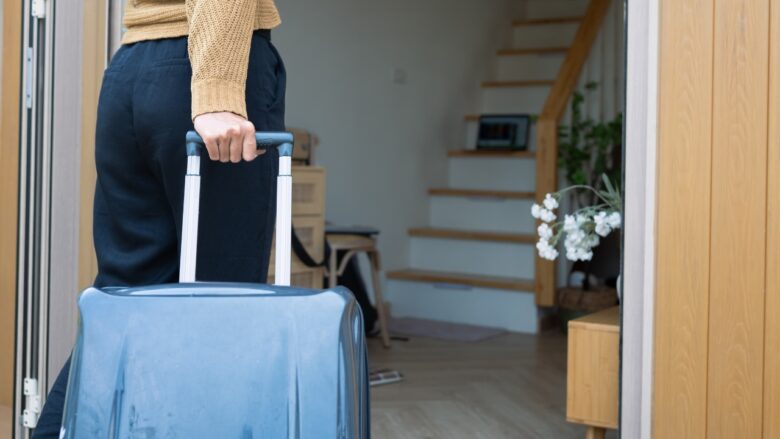 Traveler arrives home with a suitcase after a trip