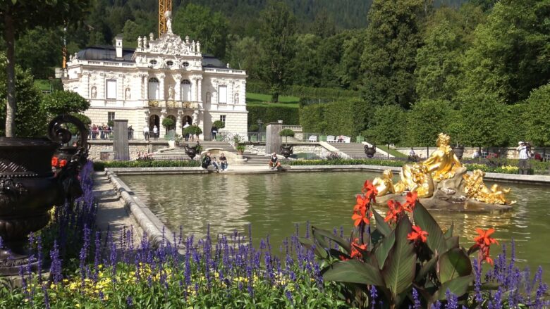 Linderhof Palace with its formal garden, pool, and gold fountain statue