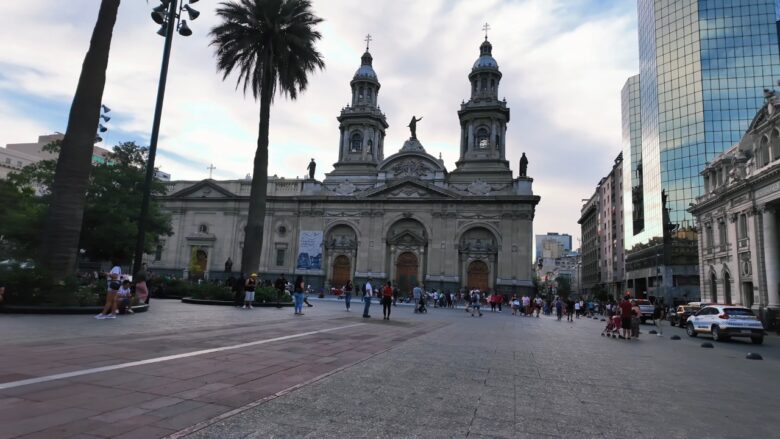 People walk near the cathedral in Santiago’s Plaza de Armas