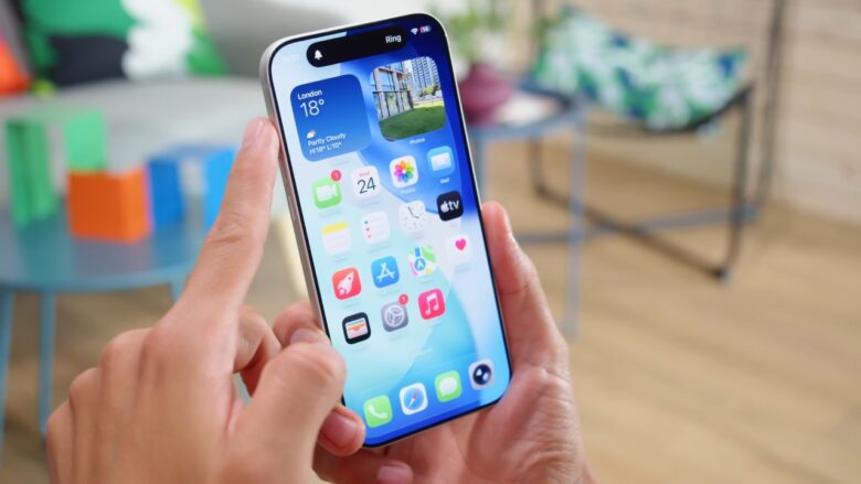 Person taps an iPhone home screen in a bright room