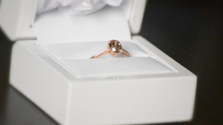 Diamond engagement band in an open white jewelry box