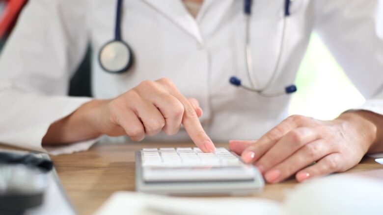 Doctor uses a calculator for health insurance costs in a child support case