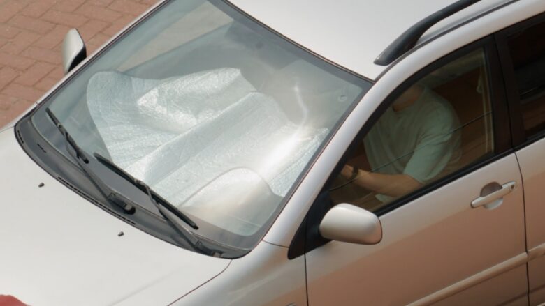 A windshield sunshade helps protect a parked car during hot weather