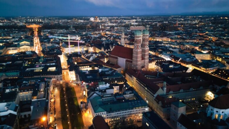 Aerial view of Munich at dusk with Frauenkirche and city lights