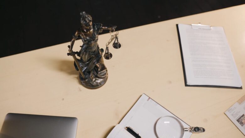 Lady Justice statue beside legal documents for state child support rules