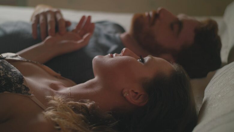 Adult couple lying together in bed and discussing boundaries before exploring a shared kink.