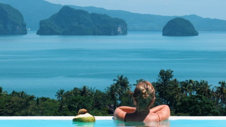 Woman in an infinity pool overlooks the sea and islands near Koh Samui