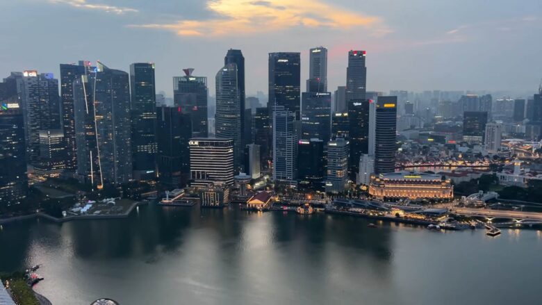 Singapore waterfront skyline illuminated at dusk