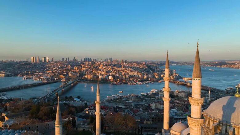 Panoramic view of Istanbul with mosque minarets, dense city buildings and the Bosphorus.