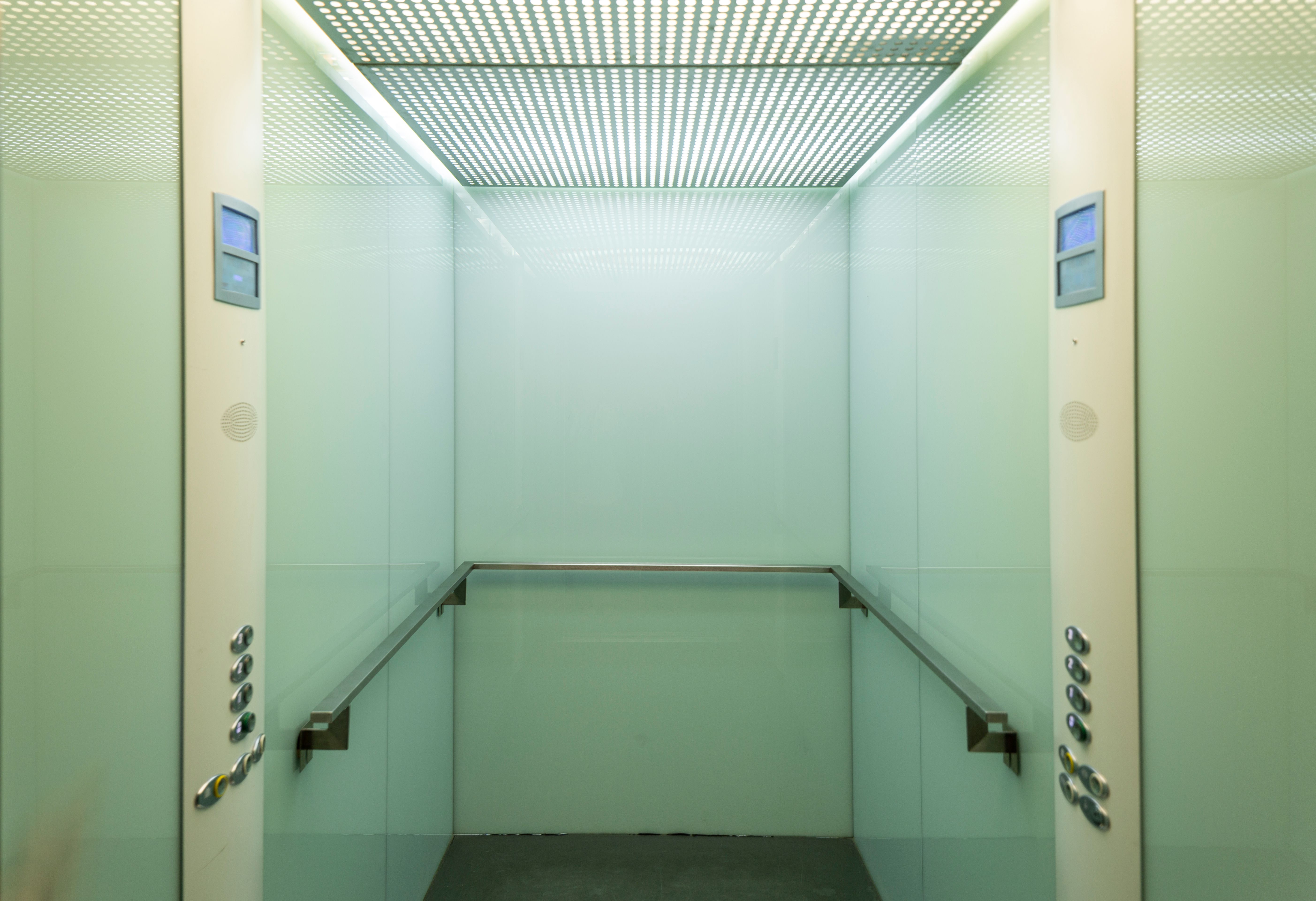 Minimalist elevator cabin with clean finishes and soft ambient lighting