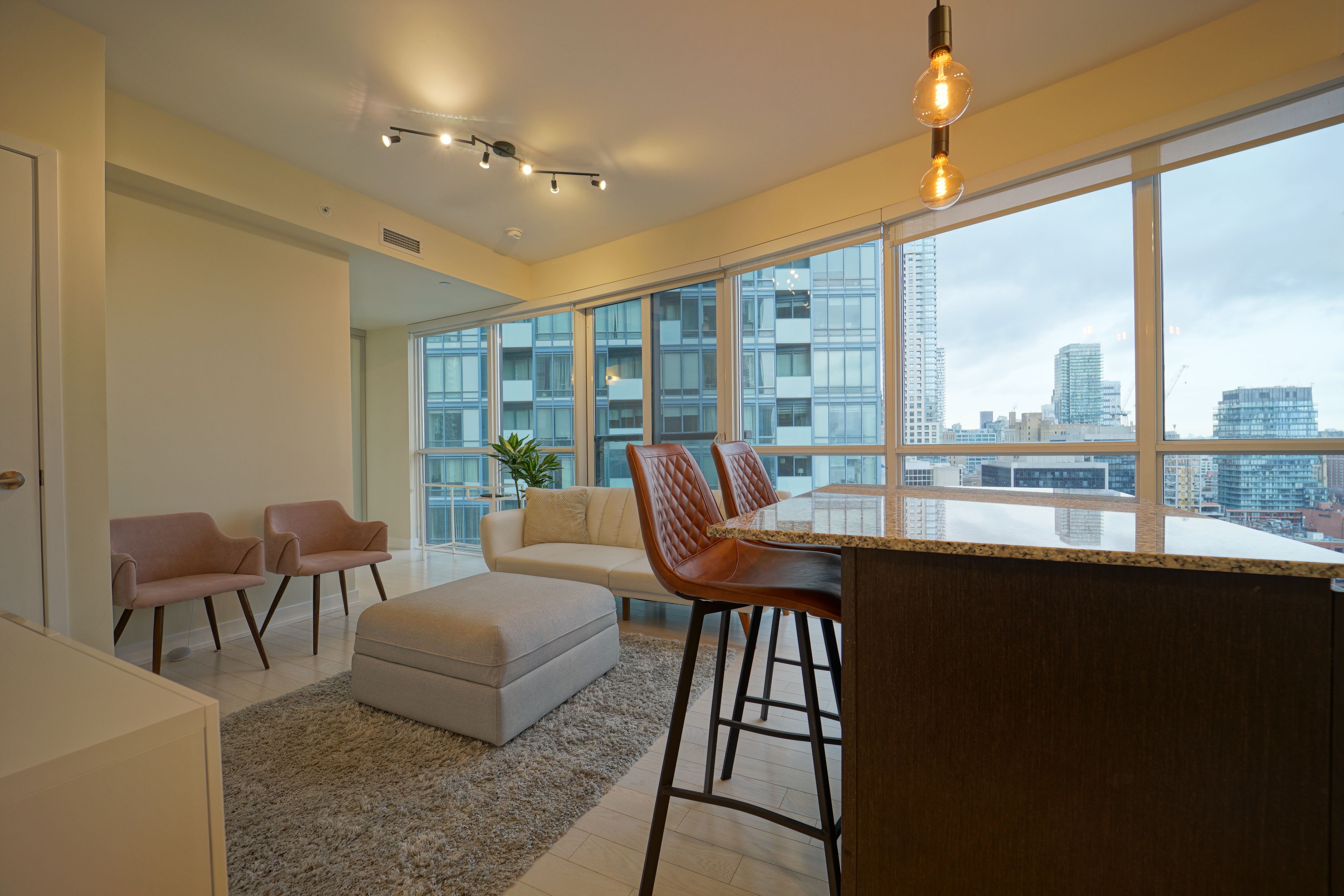 Refined condominium living room with stylish furnishings and expansive city views